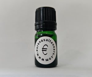 Small green bottle with a black cap on a light gray background